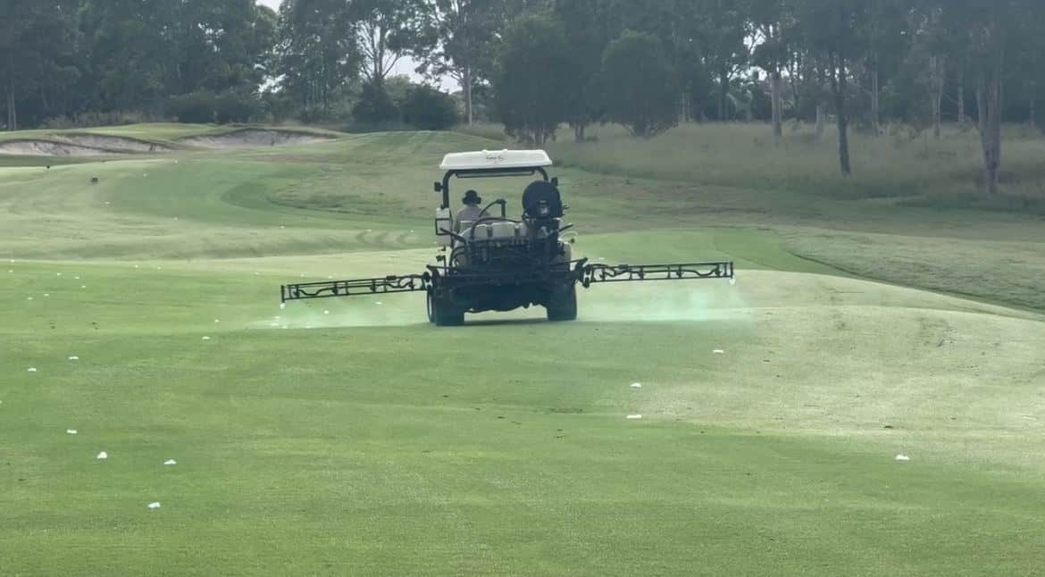 Independent turf agronomist applying registered plant protection products with a boom sprayer on a fairway